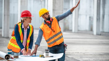 Two construction workers discussing a job site